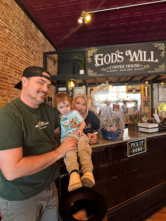 A family, owners of God's Will Coffee House, smile during a visit from The Castlewood Senior Living.